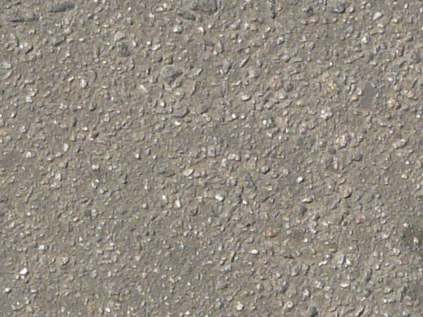 Consistent road of asphalt in light grey tone with slightly rough, flat surface.
